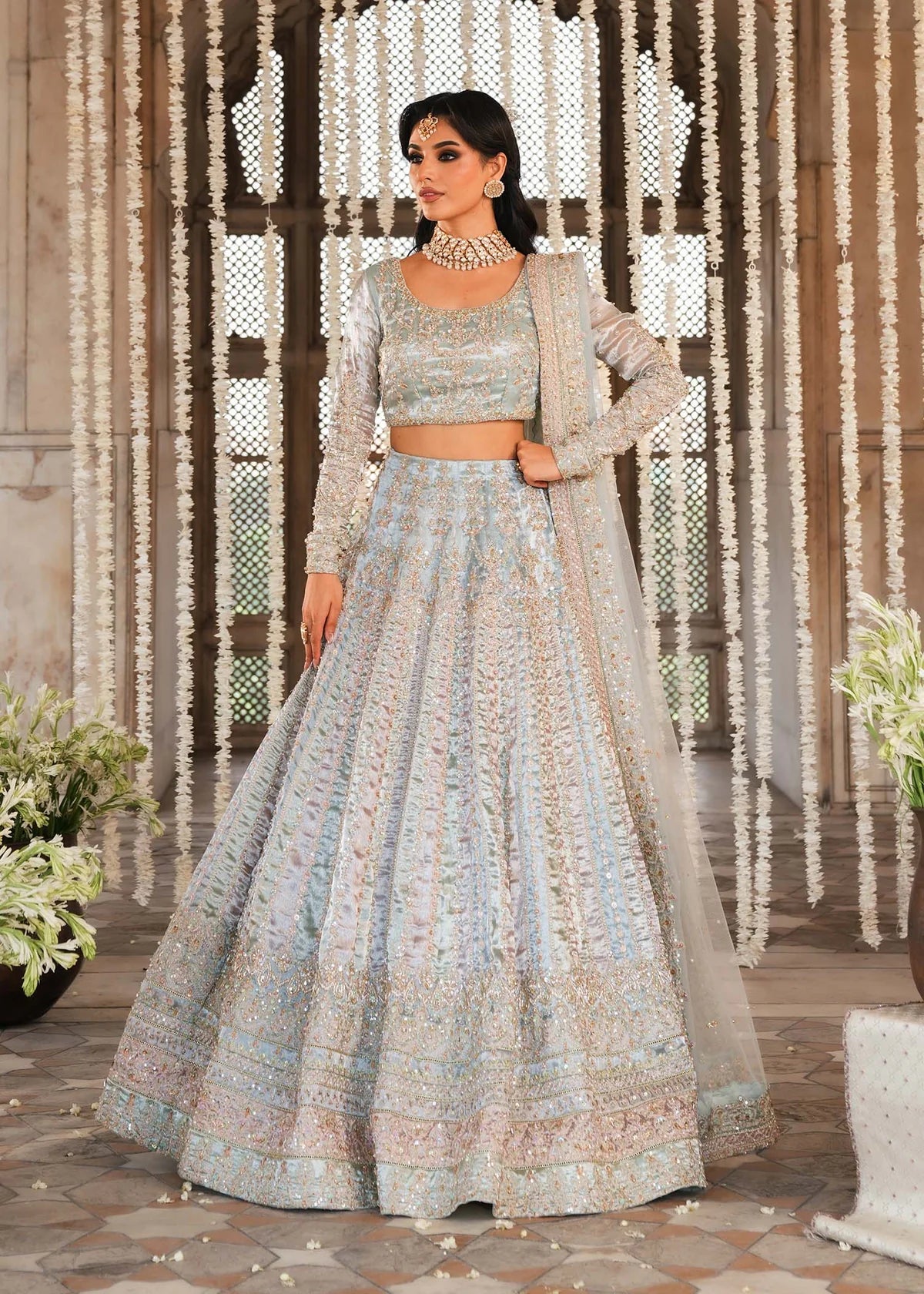 MADHU – Powder blue bridal lehenga choli with hand embroidery and net dupatta. Stitched Pakistani wedding wear online at Pakistanimoda.