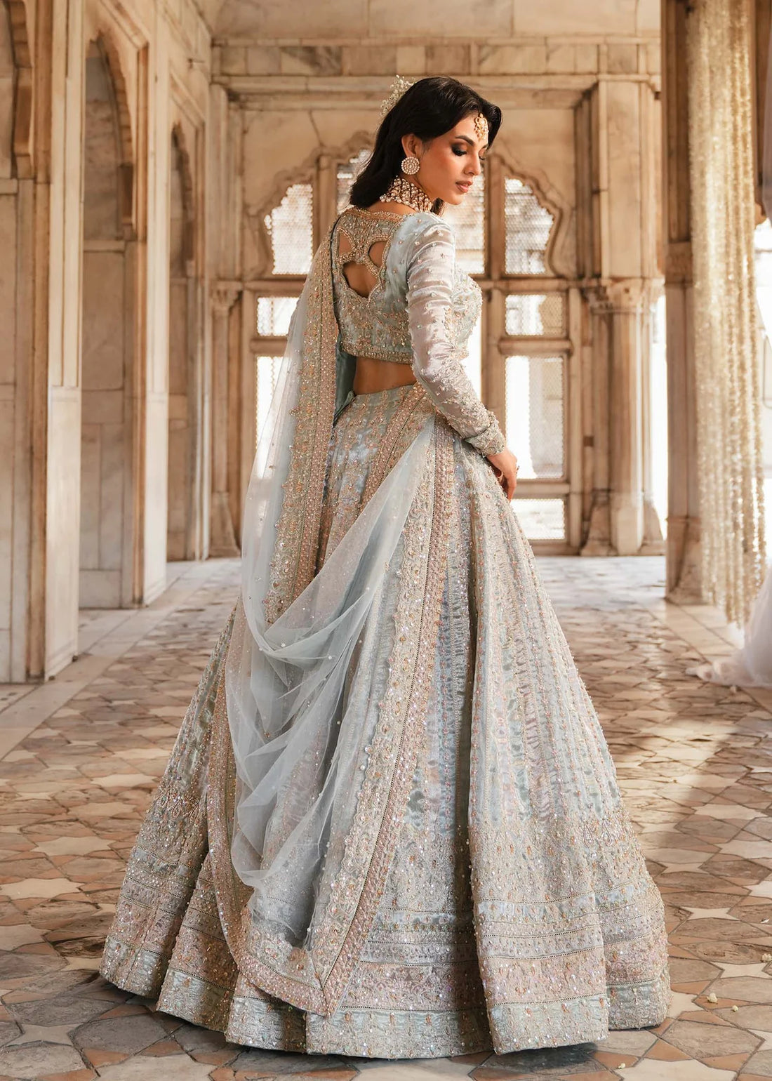 MADHU – Powder blue bridal lehenga choli with hand embroidery and net dupatta. Stitched Pakistani wedding wear online at Pakistanimoda.