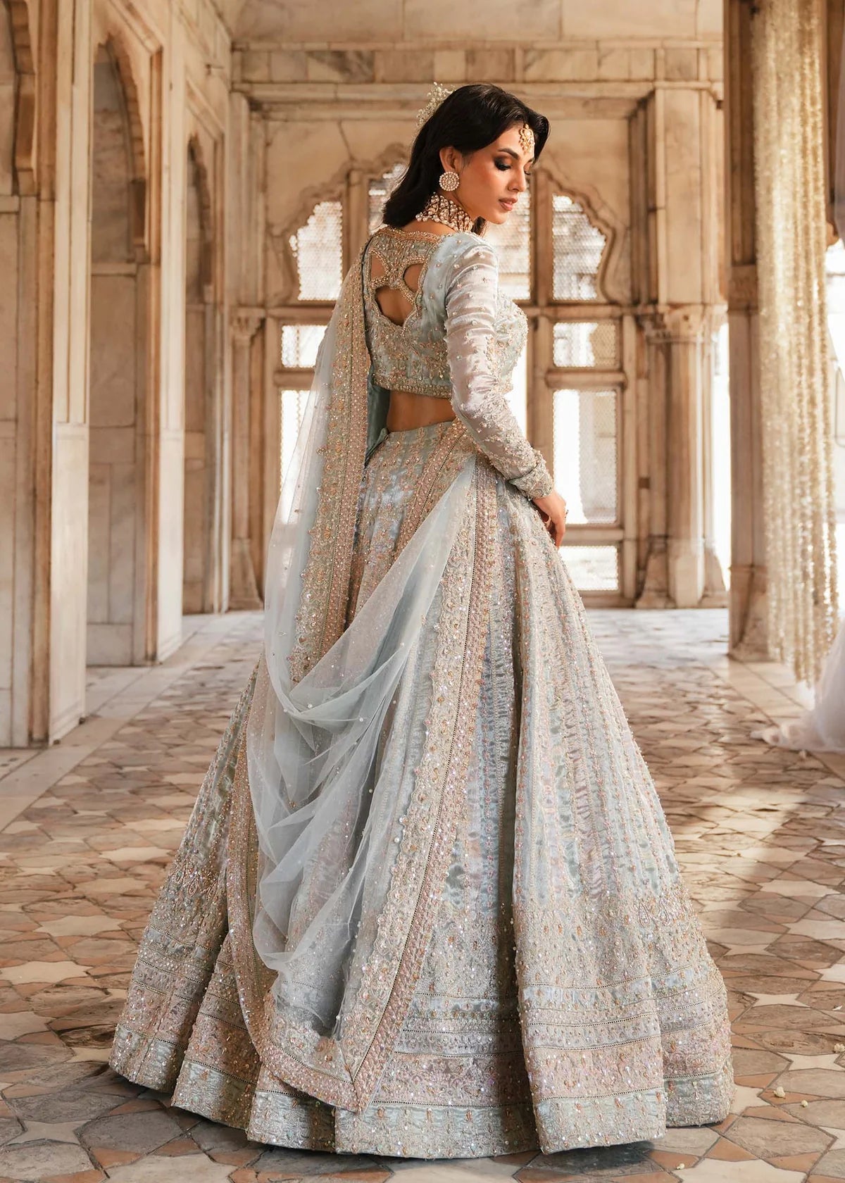 MADHU – Powder blue bridal lehenga choli with hand embroidery and net dupatta. Stitched Pakistani wedding wear online at Pakistanimoda.