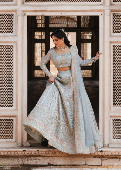 MADHU – Powder blue bridal lehenga choli with hand embroidery and net dupatta. Stitched Pakistani wedding wear online at Pakistanimoda.