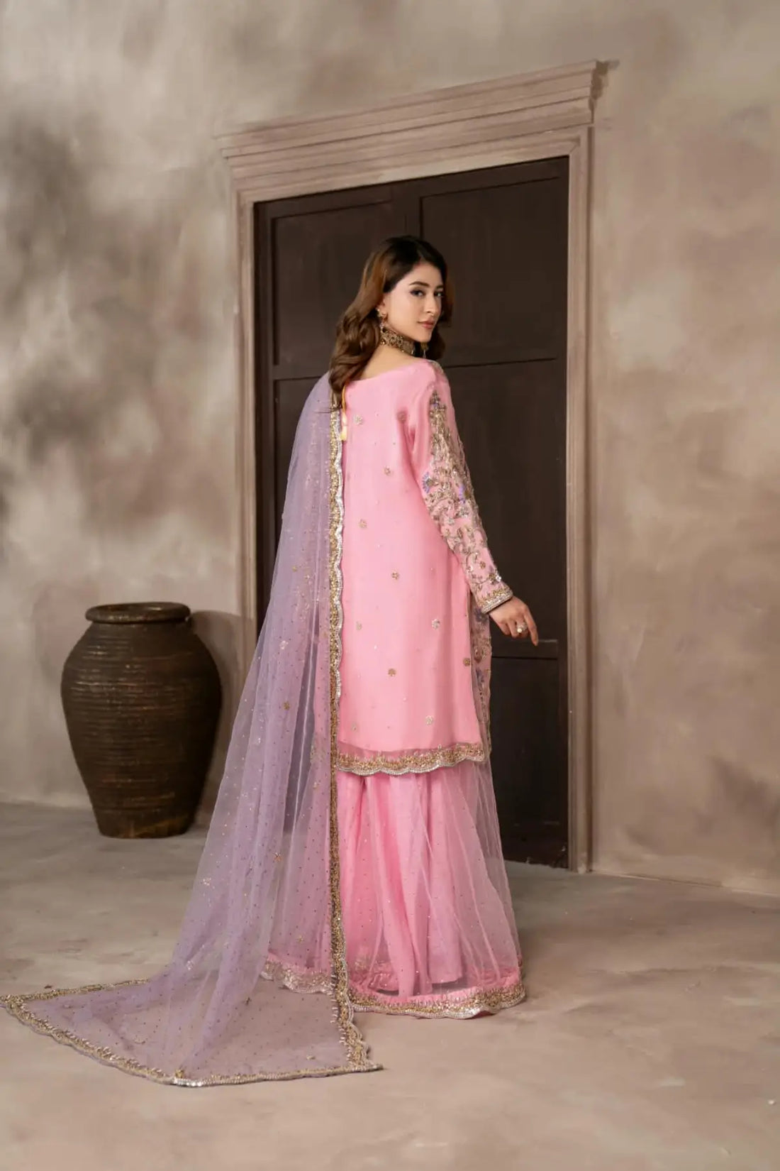 Mahgul powder pink hand embellished organza wedding suit with Kamdani net sharara and lavender net dupatta by MariamRaj