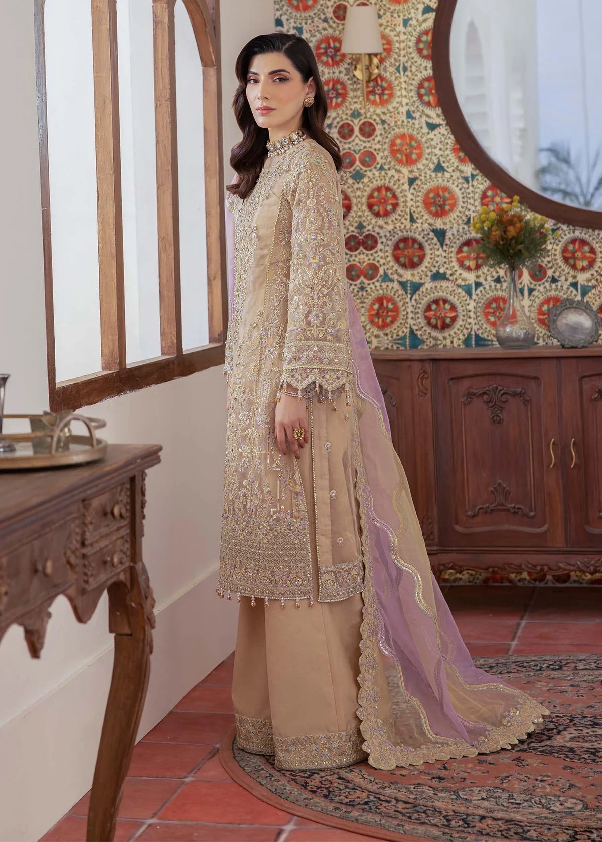 ude Pakistani straight shirt dress with sequin and beadwork, paired with flared pants and laser-cut dupatta – ideal for wedding guests abroad.