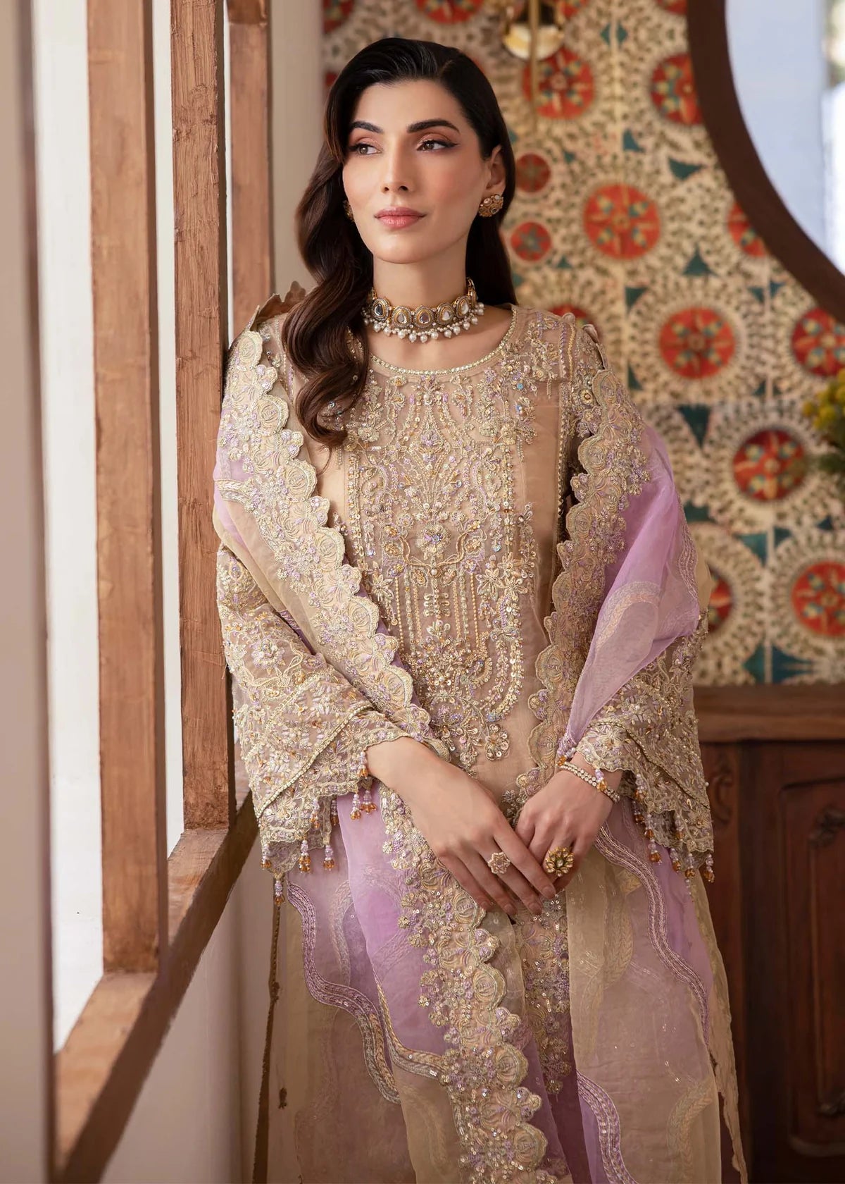 ude Pakistani straight shirt dress with sequin and beadwork, paired with flared pants and laser-cut dupatta – ideal for wedding guests abroad.