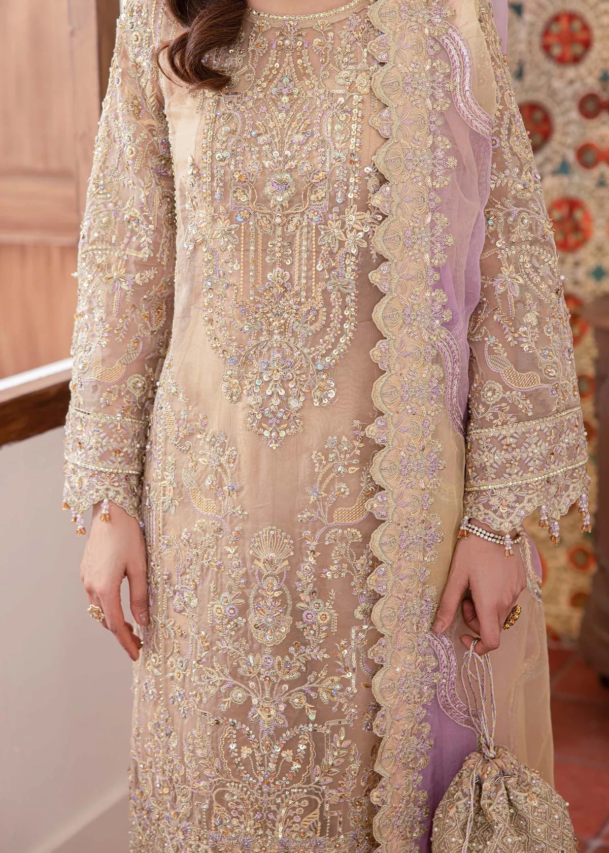 ude Pakistani straight shirt dress with sequin and beadwork, paired with flared pants and laser-cut dupatta – ideal for wedding guests abroad.