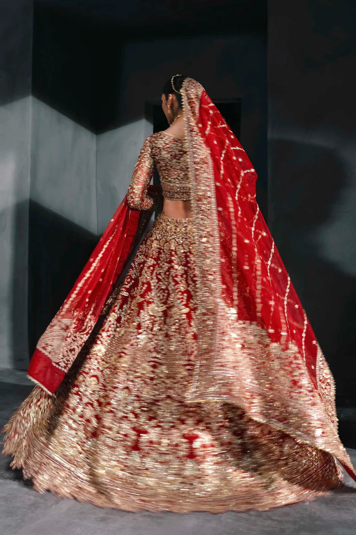 Heavily embroidered red bridal lehenga with gold floral work, full sleeves, and dupatta – perfect for Pakistani brides on Nikkah or Baraat.