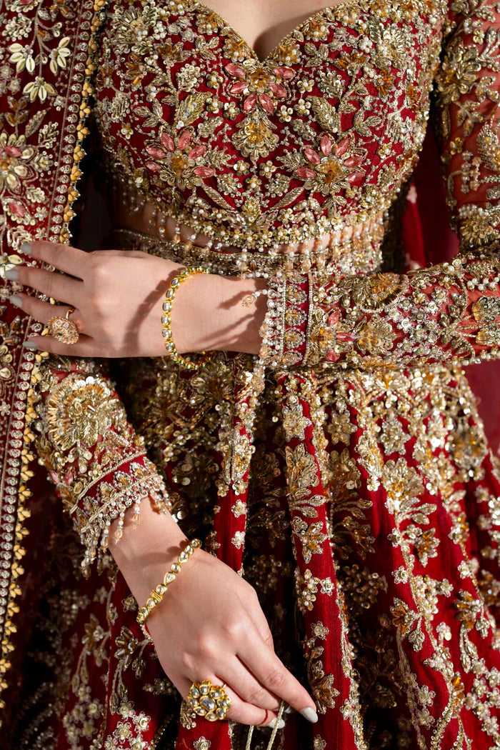 Heavily embroidered red bridal lehenga with gold floral work, full sleeves, and dupatta – perfect for Pakistani brides on Nikkah or Baraat.
