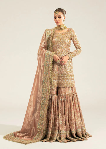 Meeram pink bridal gharara outfit with tissue dupatta and hand embellishments by Kanwal Malik, featuring pearl and sequin work.