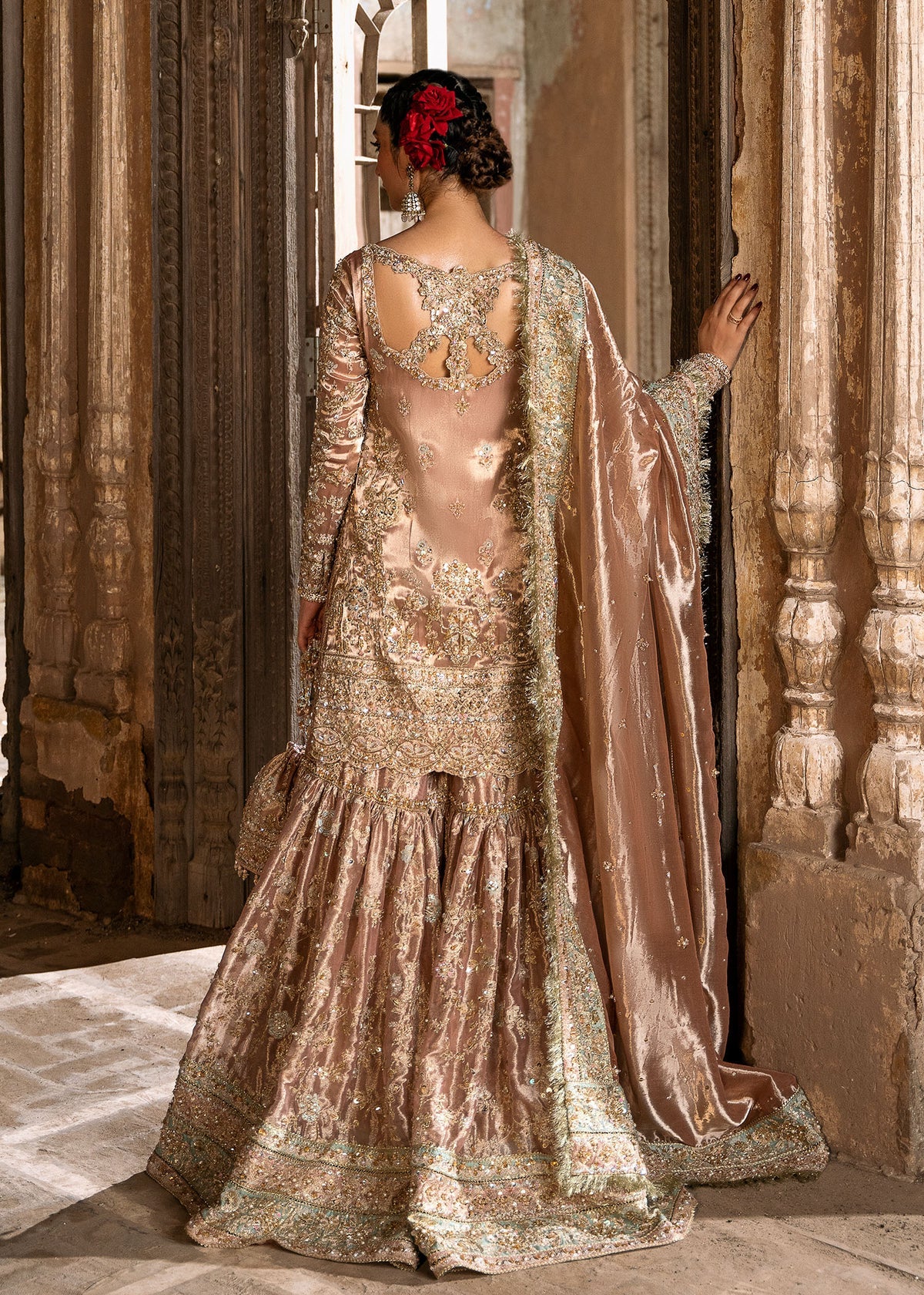 Meeram pink bridal gharara outfit with tissue dupatta and hand embellishments by Kanwal Malik, featuring pearl and sequin work.