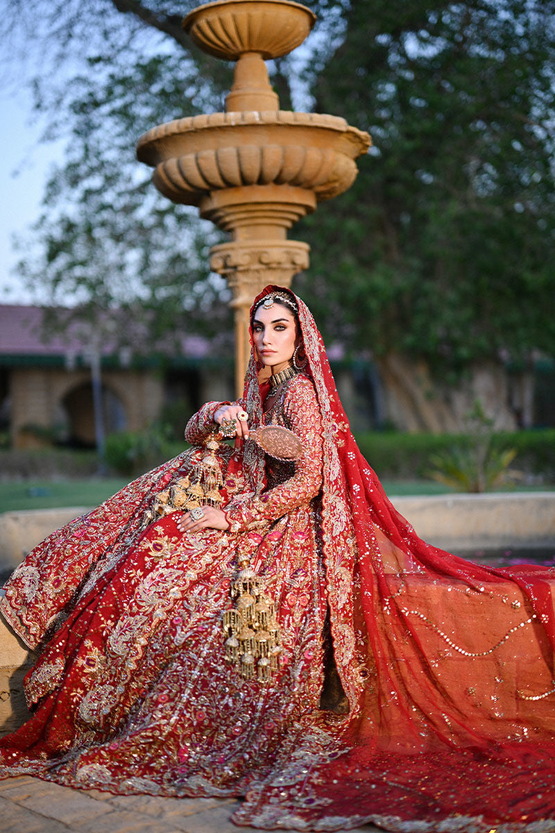 Crimson red Pakistani bridal lehenga with Mughal motifs, heavy hand embellishments, and jaal embroidered dupatta – perfect for brides in USA, UK, and Canada.