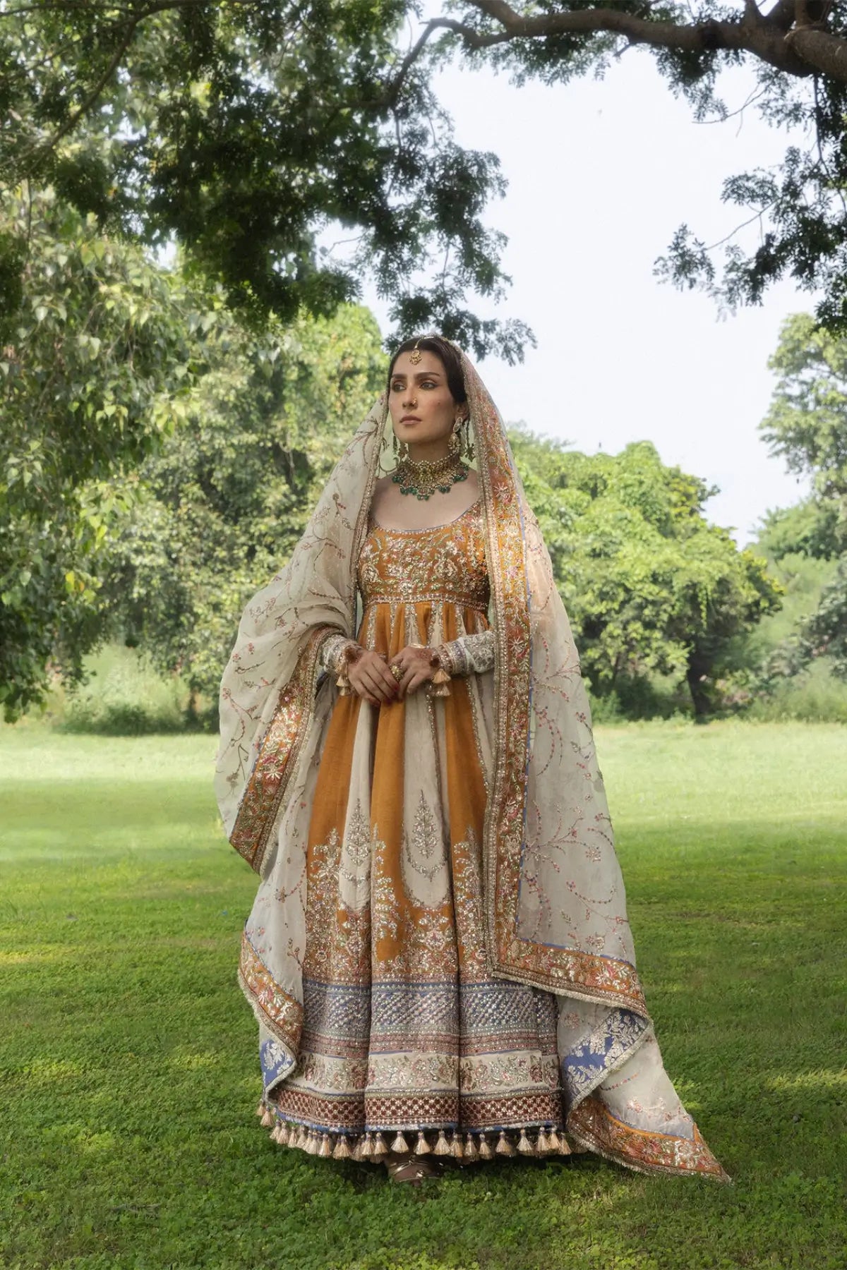 Mehru Hussain Rehar mustard raw silk stitched wedding Peshwas with indigo blue churidar and embroidered ivory organza dupatta