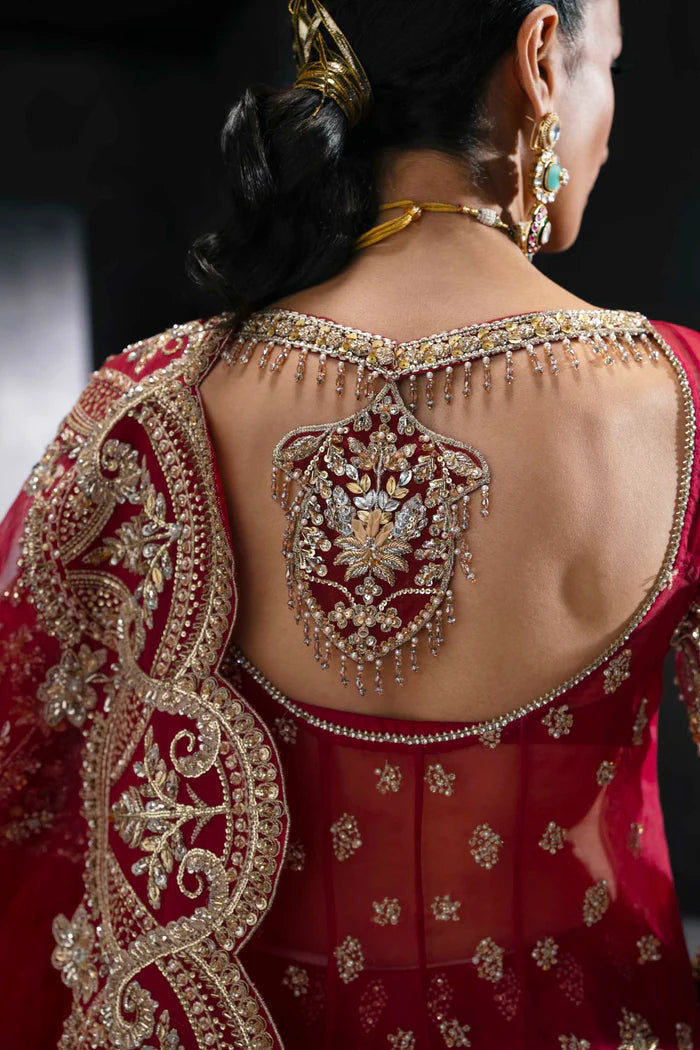 Deep crimson bridal lehenga with gold embroidery, full sleeves, flared skirt, and dramatic dupatta – perfect for overseas Pakistani and Indian brides.