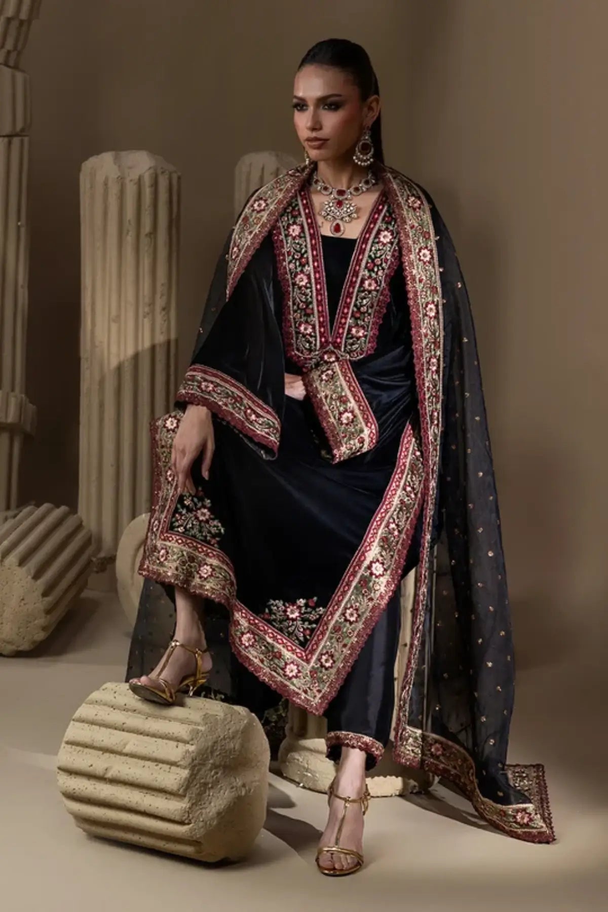 Midnight Tapestry jet black velvet stitched suit with maroon and gold zardozi embroidery, Sheesha silk pants and embellished organza dupatta.