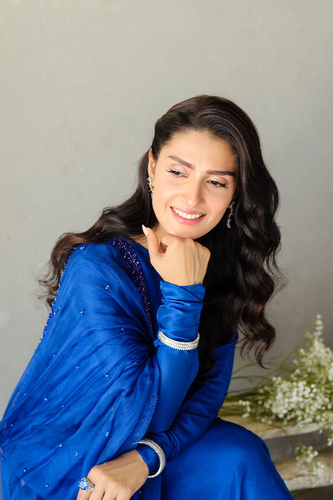 Blue raw silk formal dress with embellished borders and organza dupatta.