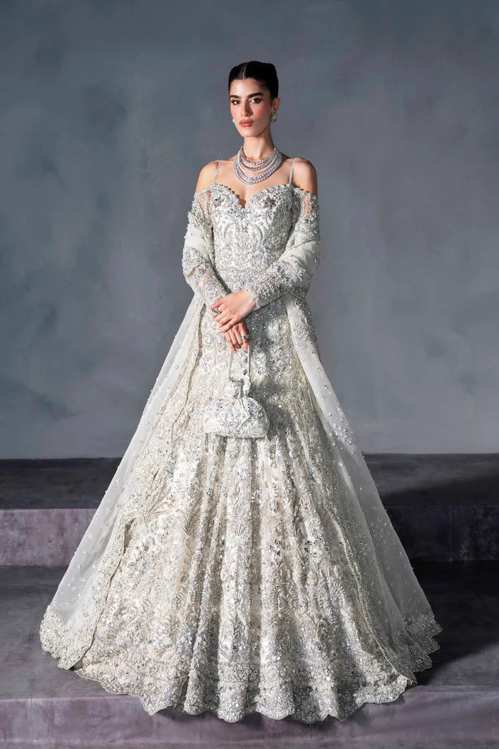 Ice silver bridal lehenga with off-shoulder choli, crystal handwork, flared skirt, and net dupatta – perfect for modern South Asian brides.