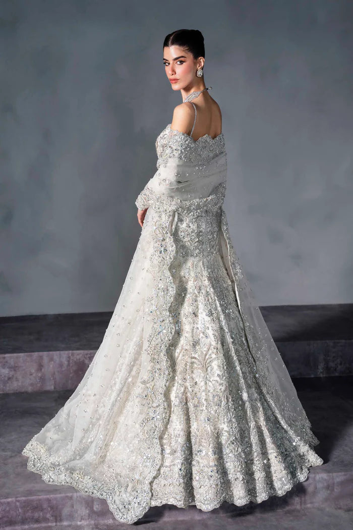 Ice silver bridal lehenga with off-shoulder choli, crystal handwork, flared skirt, and net dupatta – perfect for modern South Asian brides.