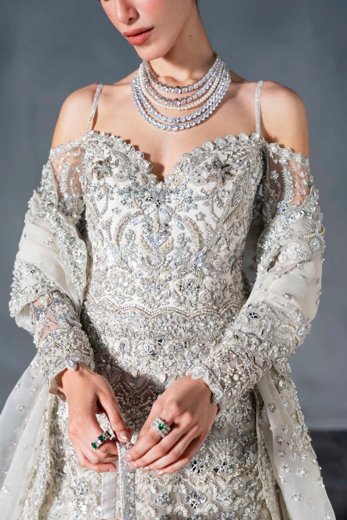 Ice silver bridal lehenga with off-shoulder choli, crystal handwork, flared skirt, and net dupatta – perfect for modern South Asian brides.