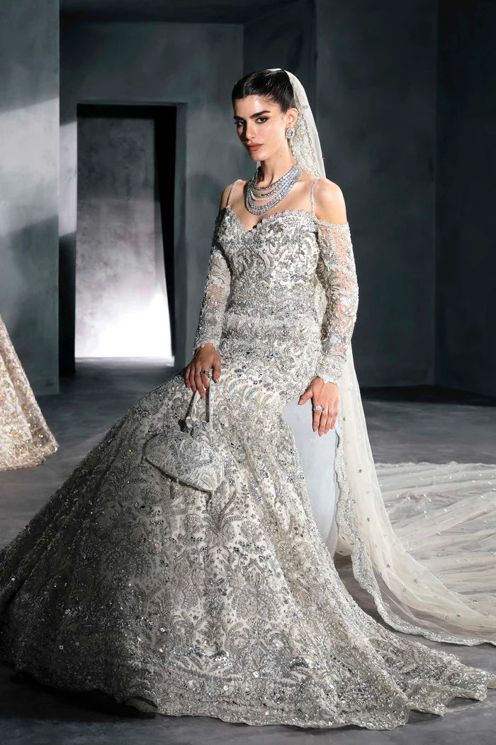 Ice silver bridal lehenga with off-shoulder choli, crystal handwork, flared skirt, and net dupatta – perfect for modern South Asian brides.