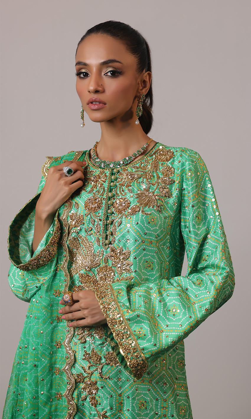 Green raw silk chunri print outfit with gold handwork, scalloped chiffon dupatta, and teal embroidered ezaar – NAOW-554 by Pakistanimoda