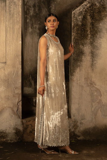 Nude velvet halter shirt with silver embellishments, pearl hangings, silk pants, and organza dupatta with silver hem – perfect for formal events 2025.