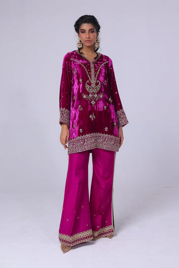 Viva magenta velvet short shirt with hand sequins, tilla, gold lace, raw silk pants with slits, and matching organza dupatta – perfect partywear 2025.