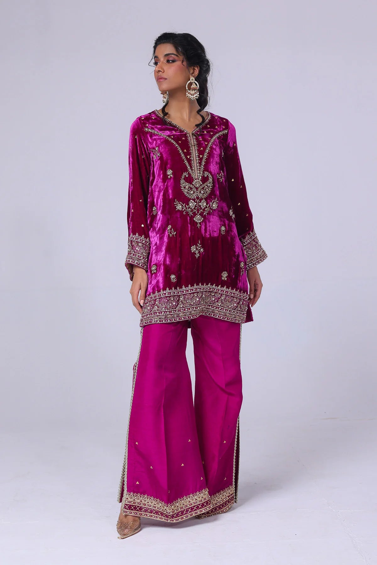 Viva magenta velvet short shirt with hand sequins, tilla, gold lace, raw silk pants with slits, and matching organza dupatta – perfect partywear 2025.