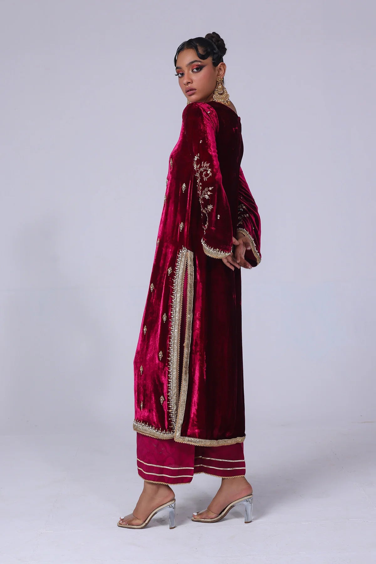 Cherry velvet shirt with naqshi, gota, and cut dana handwork, paired with embossed silk pants and matching organza dupatta – formal wear for 2025.

