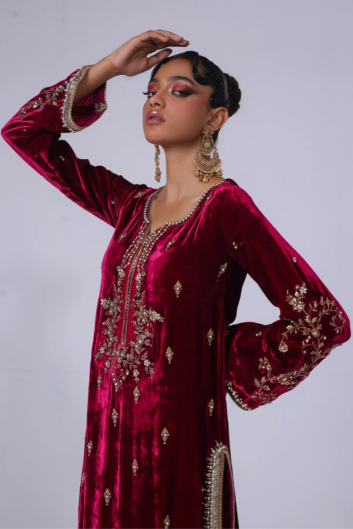 Cherry velvet shirt with naqshi, gota, and cut dana handwork, paired with embossed silk pants and matching organza dupatta – formal wear for 2025.


