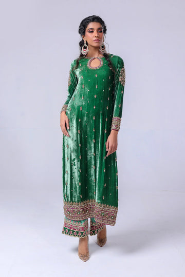 Green velvet shirt with keyhole neckline, naqshi and dabka handwork, silk pants with embellished hem, and matching organza dupatta – festive wear 2025.


