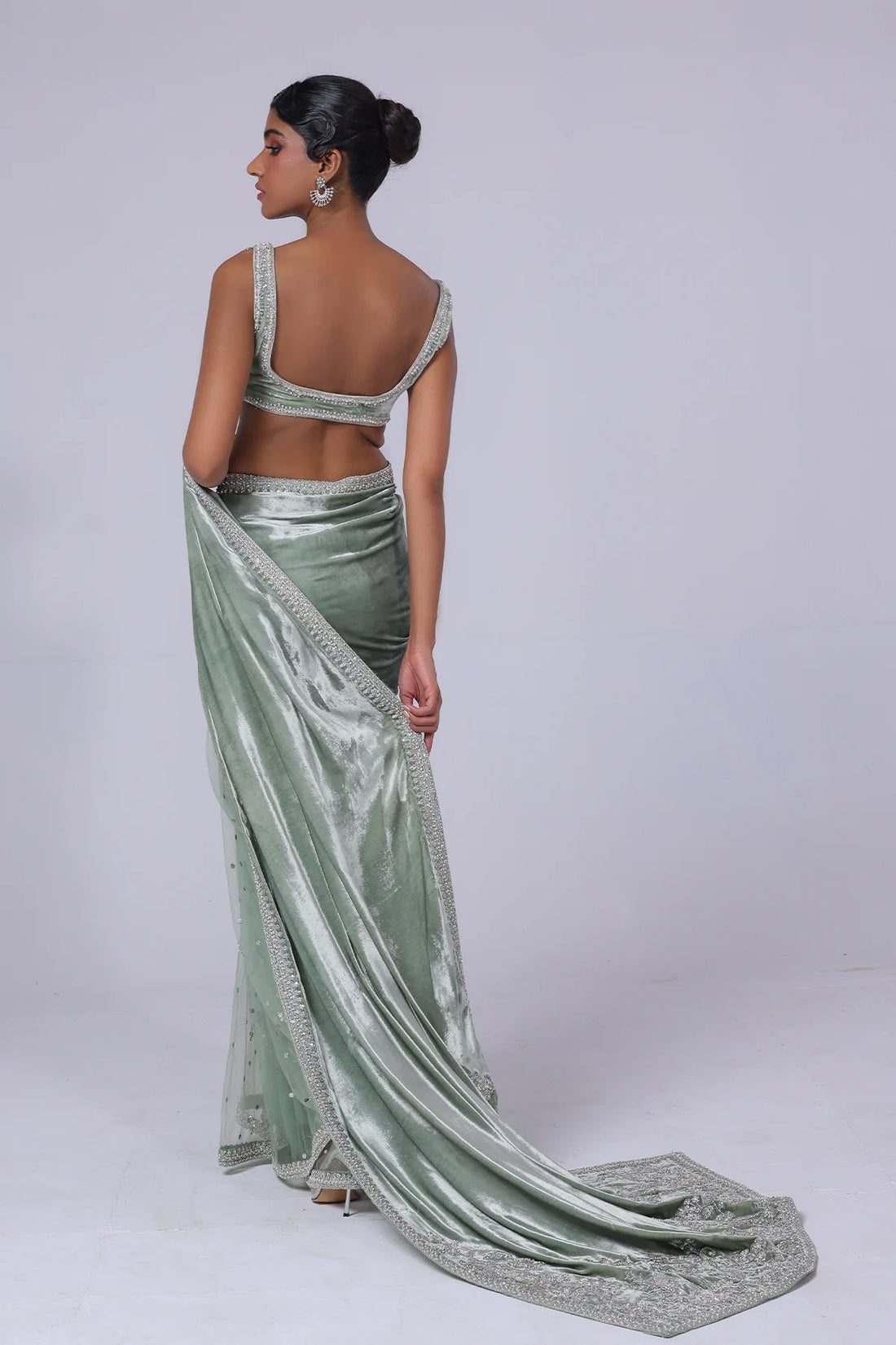 Light green Pakistani saree with velvet pallu, net mukesh fall, and silver embellished blouse – ideal for receptions and formal events in 2025.