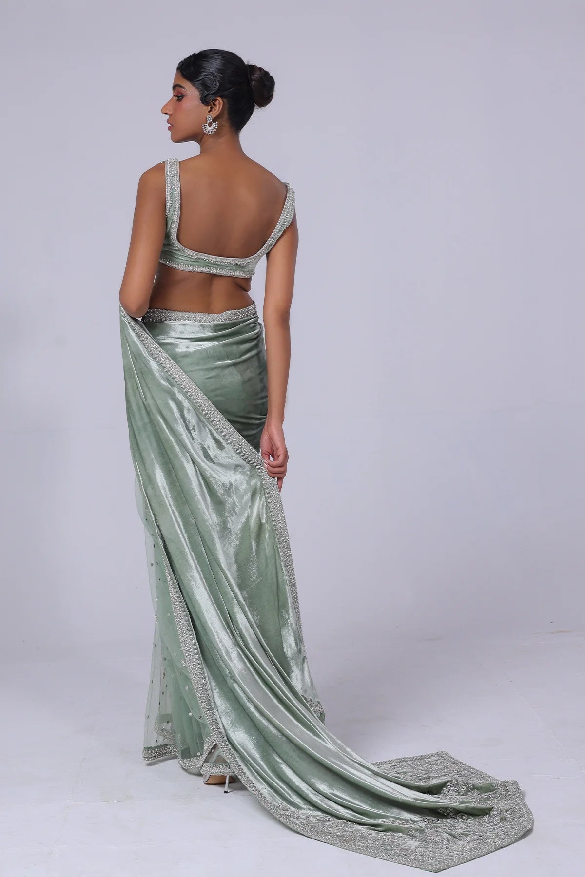 Light green Pakistani saree with velvet pallu, net mukesh fall, and silver embellished blouse – ideal for receptions and formal events in 2025.