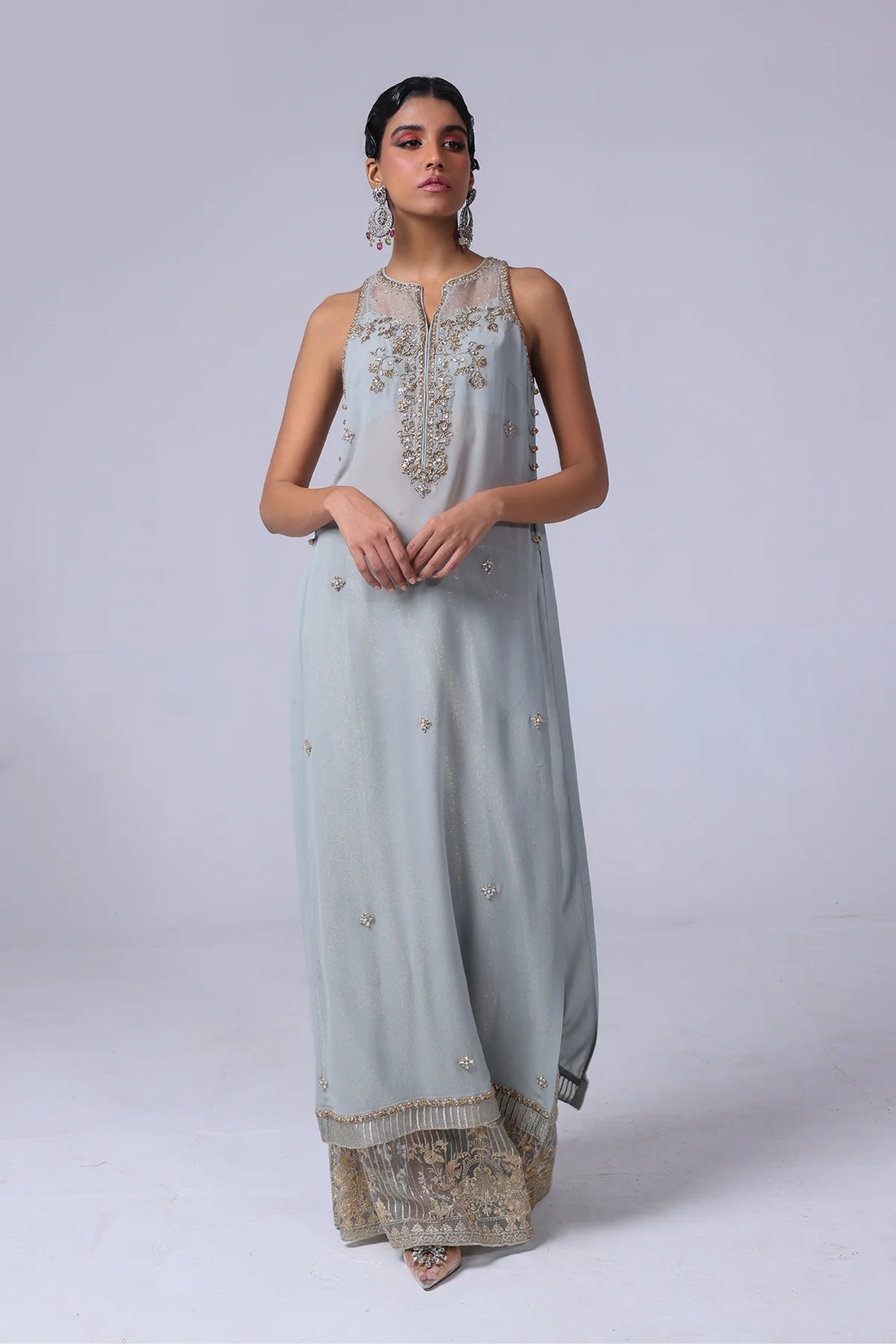 Sleeveless embellished georgette shirt with champagne & silver crystals, velvet flared pants with organza hem, and matching organza dupatta – party-ready.