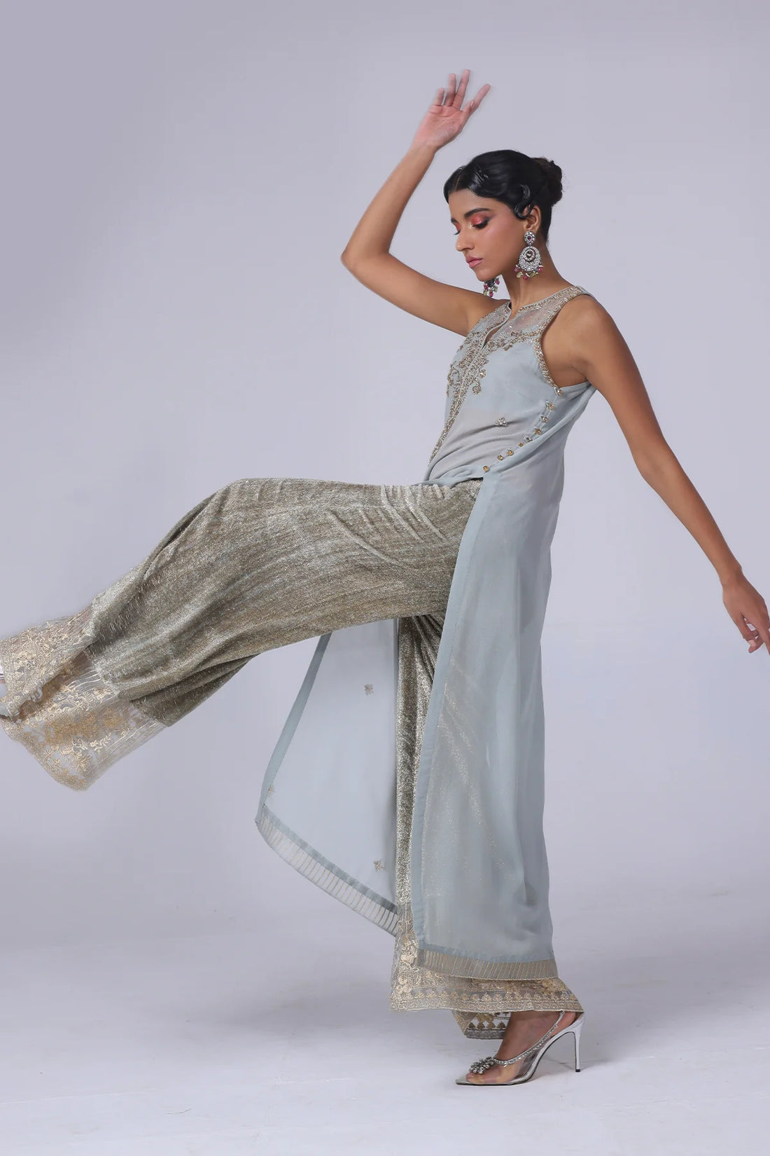 Sleeveless embellished georgette shirt with champagne & silver crystals, velvet flared pants with organza hem, and matching organza dupatta – party-ready.