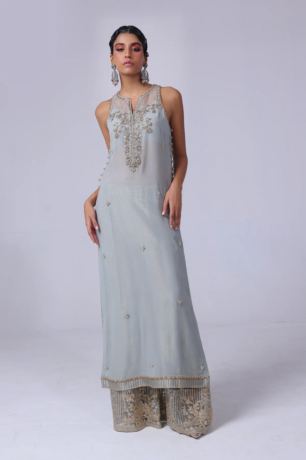 Sleeveless embellished georgette shirt with champagne & silver crystals, velvet flared pants with organza hem, and matching organza dupatta – party-ready.