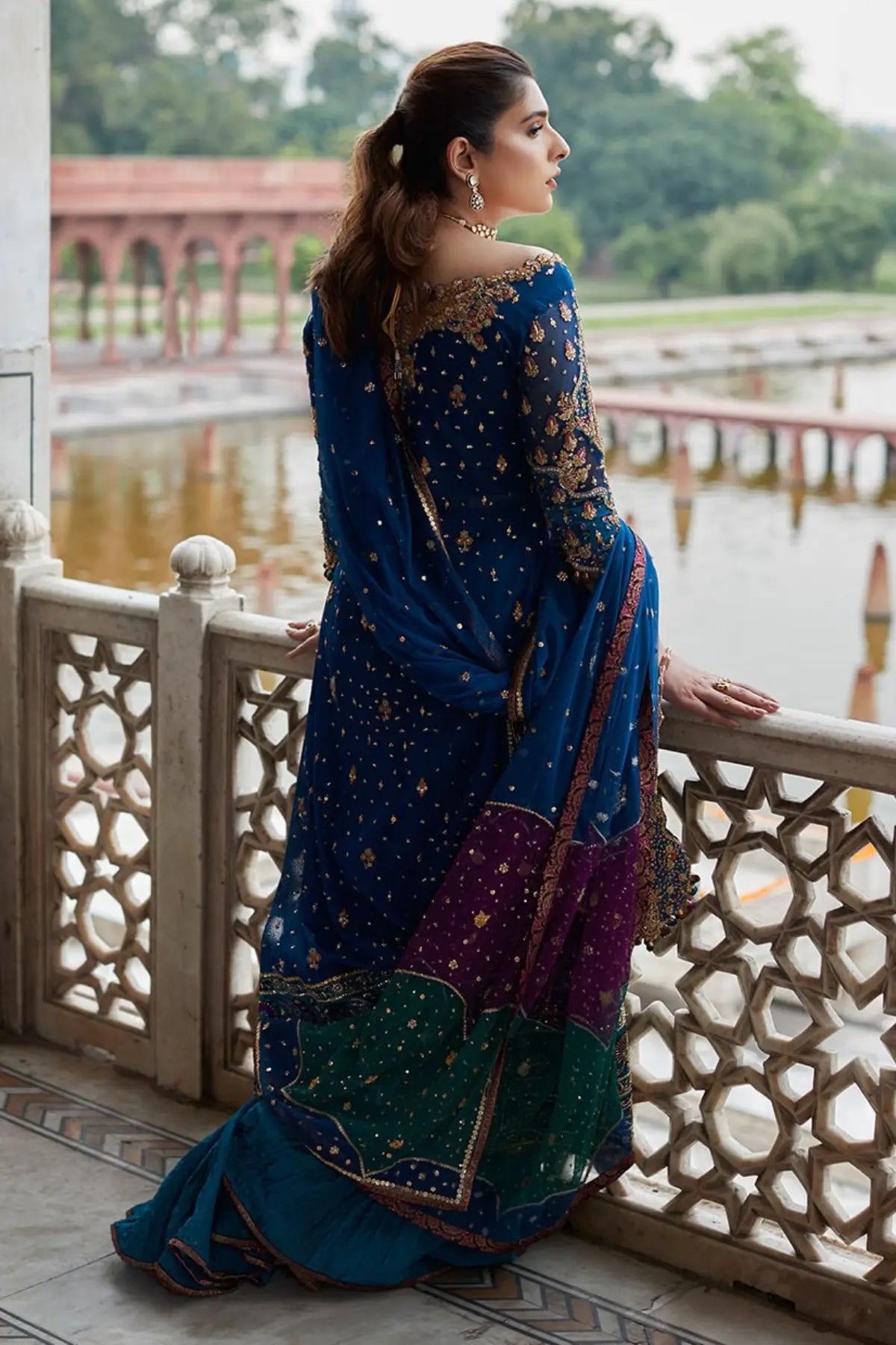 Navy peacock blue stitched formal dress with hand embellishment, net kalidaar shirt and crushed lehenga at Pakistanimoda