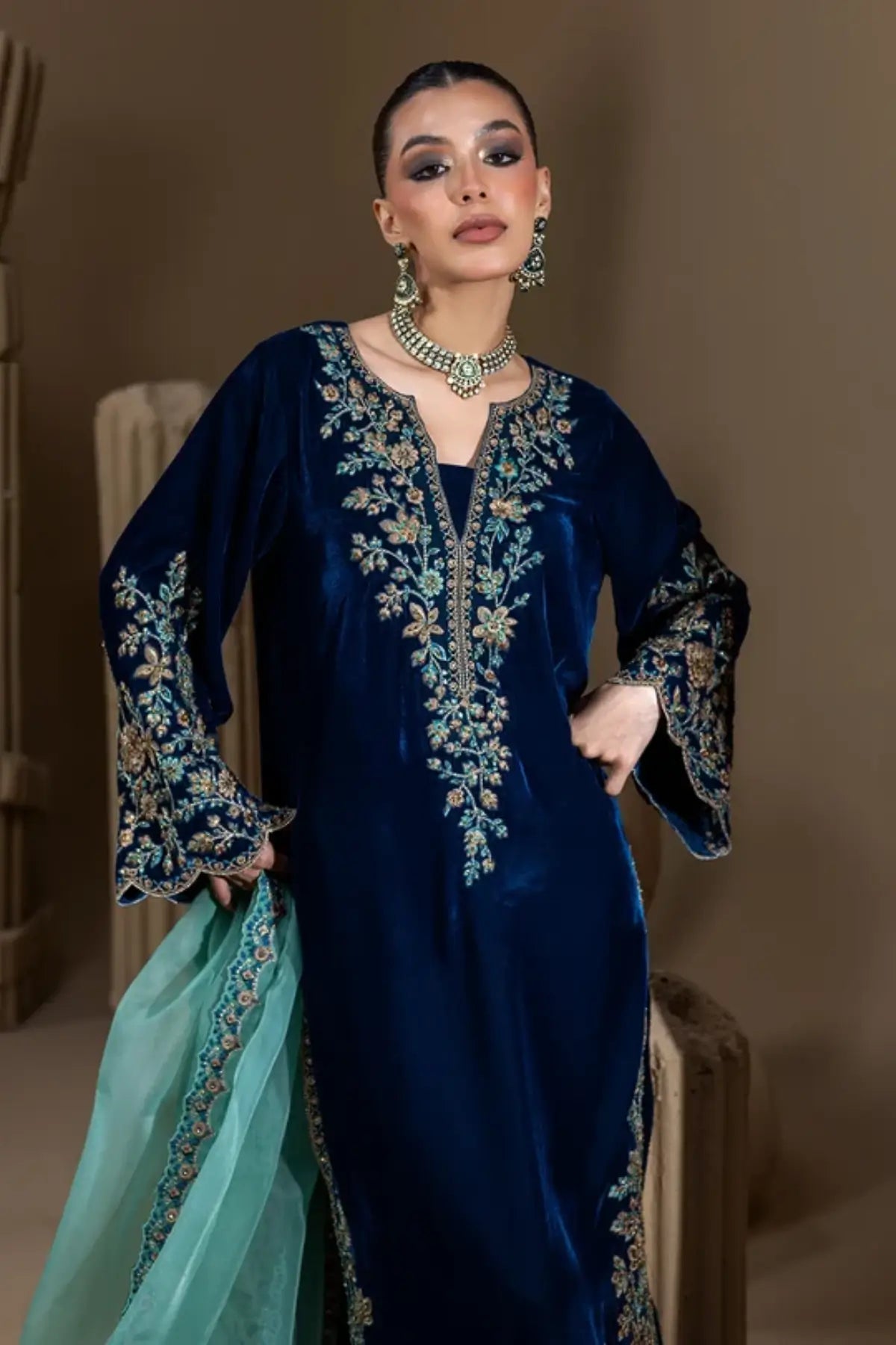 Neelum peacock teal embroidered velvet stitched formal kaftan with floral hand embellishments, Sheesha silk pants and organza dupatta.