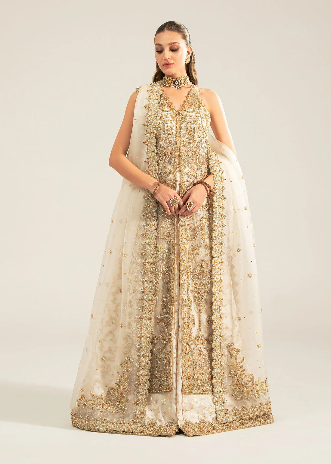 Nisha stitched ivory sharara outfit by Kanwal Malik with hand-embellished Kathan organza shirt, lawn silk sharara, and a sequin-sprayed organza dupatta.