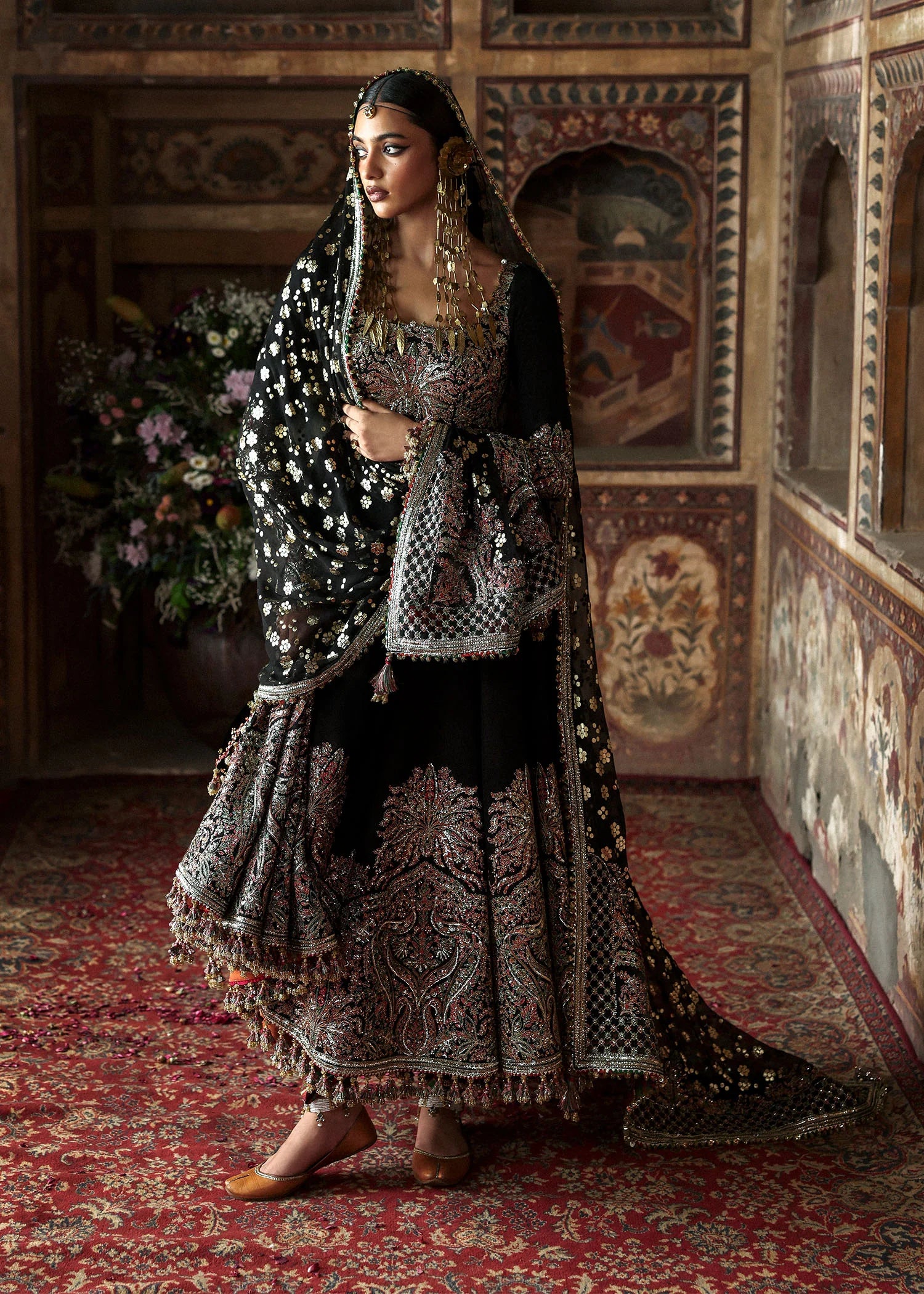 Model wearing Noor Jehan luxury black Korean raw silk embroidered peshwas with churidar and chiffon foil printed dupatta – Hussain Rehar Massarat Festive 2025.