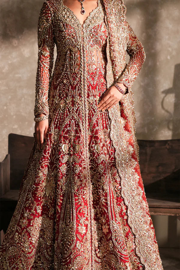 Pakistani bridal pishwas with raw silk lehenga for USA brides, featuring hand-embellished naqshi, dabka, mirror work, and mukesh with a sheer net dupatta in a graceful traditional design.