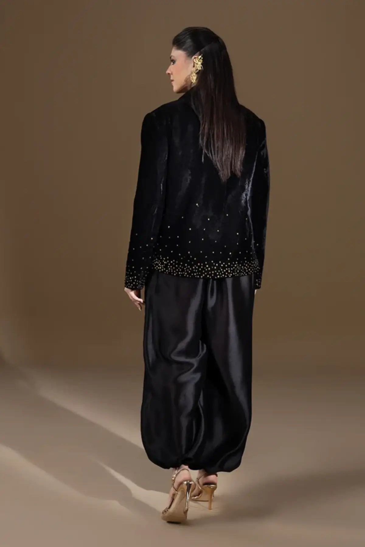 Odyssey black velvet blazer with gold zardozi floral embroidery, pure raw silk cowl and matching black balloon pants, luxury stitched formal outfit.