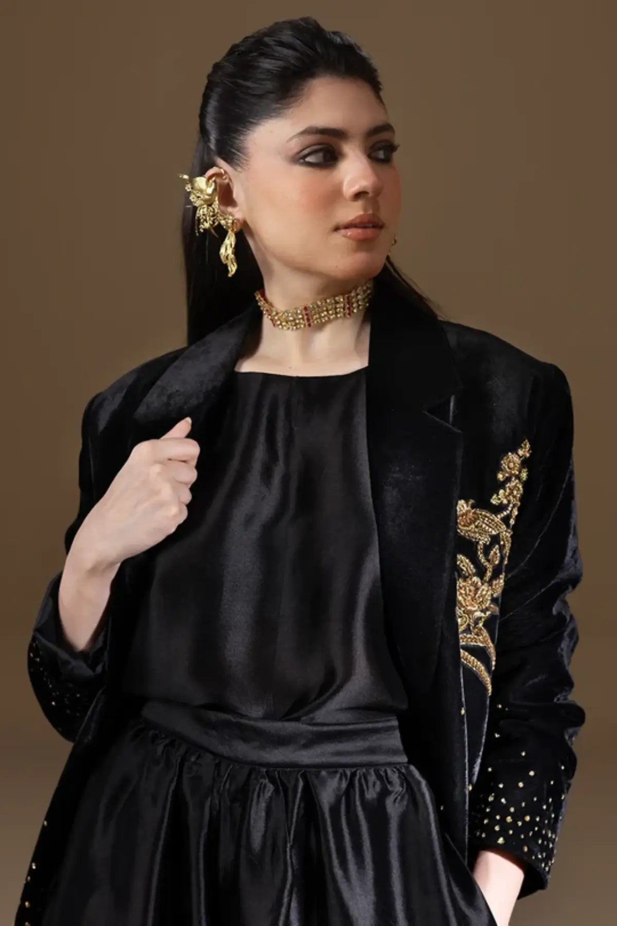 Odyssey black velvet blazer with gold zardozi floral embroidery, pure raw silk cowl and matching black balloon pants, luxury stitched formal outfit.