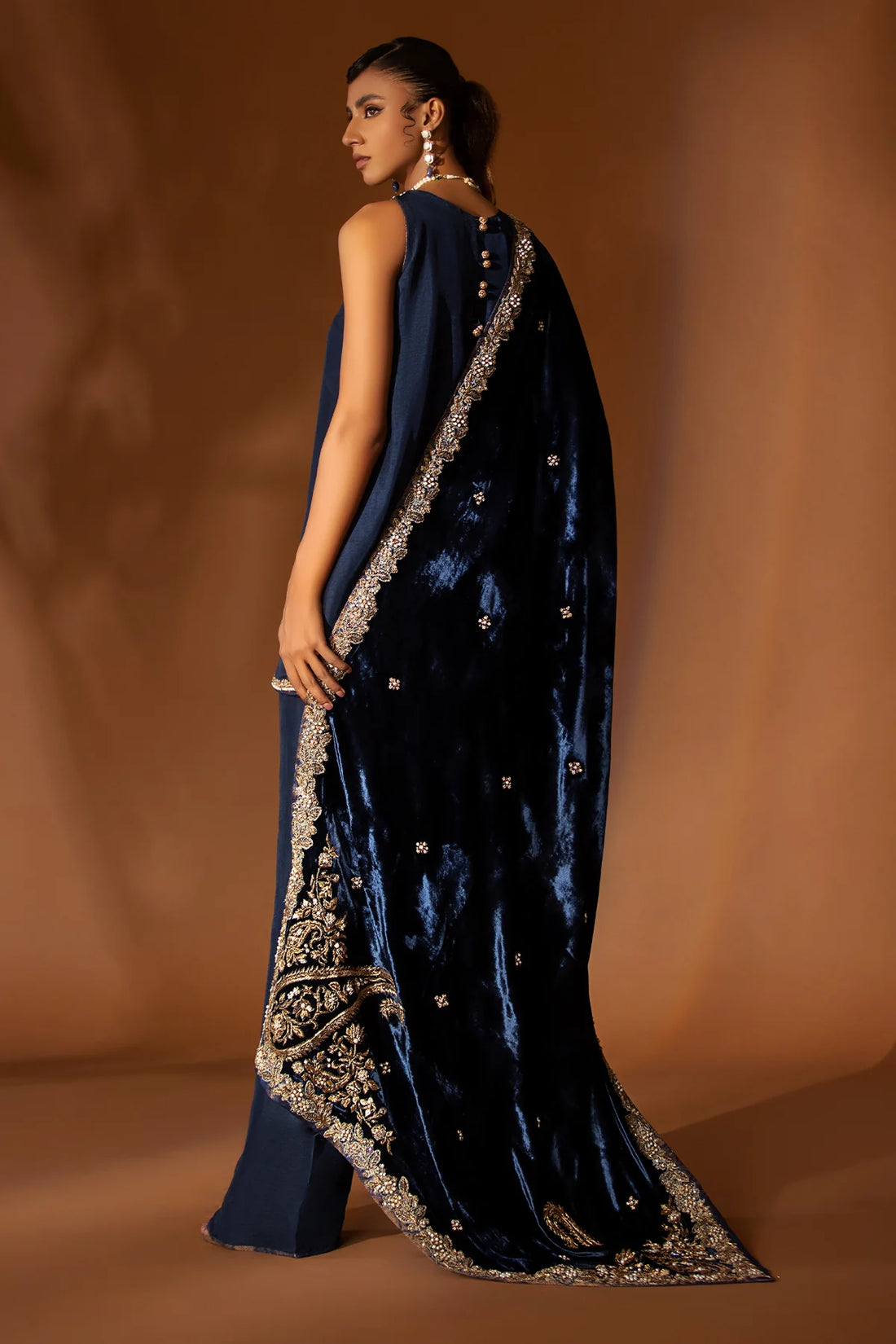 Navy blue formal outfit with hand-embellished raw silk shirt, bootcut pants, and embroidered velvet shawl – Eid wear for women from Pakistanimoda
