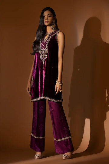 Plum velvet shirt with hand-embellished neckline, paired with embossed silk pants and a matching lace-trimmed organza dupatta for formal winter wear.