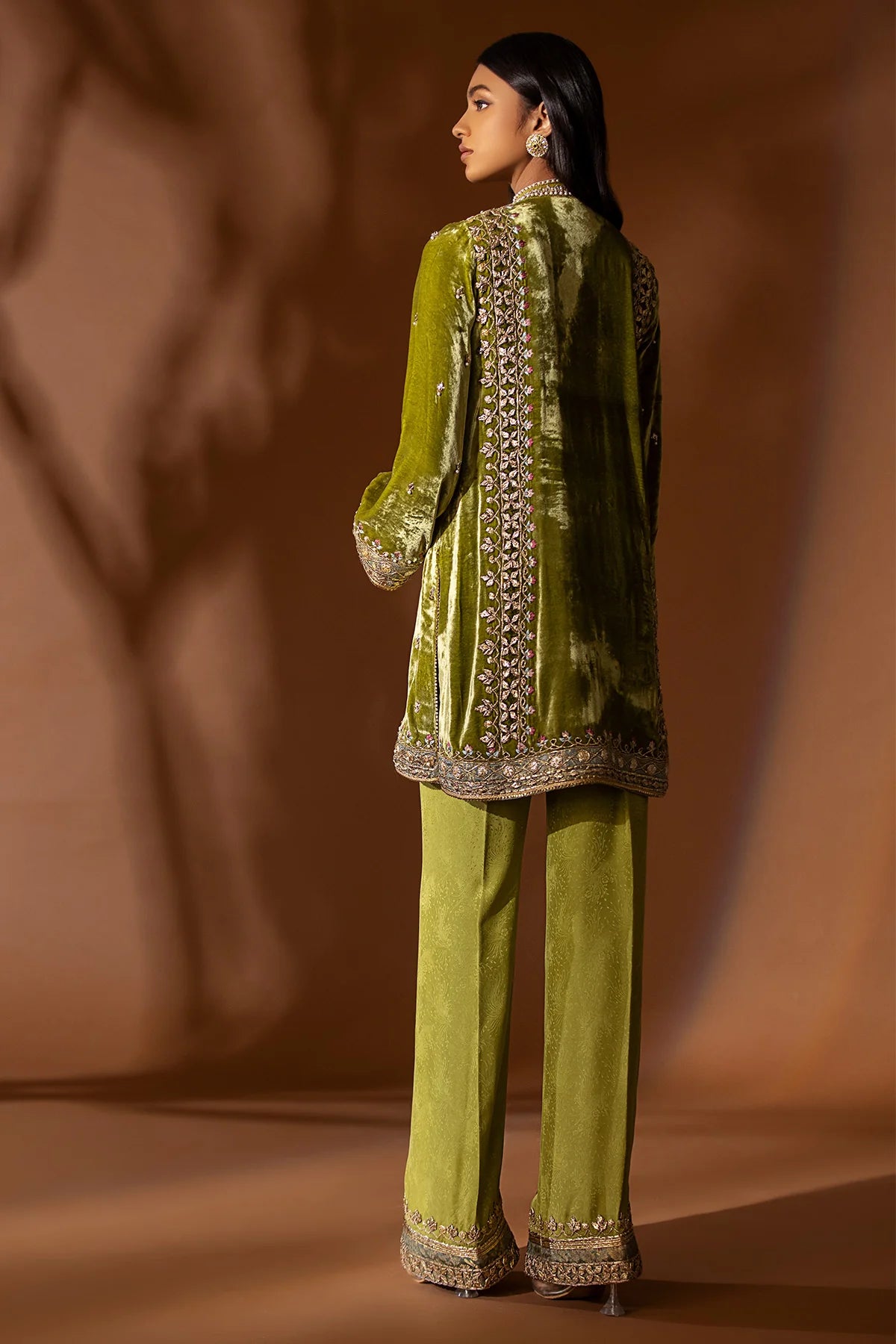 Olive green velvet kurta with pearl, sequin, and gotta embroidery, paired with embossed silk pants and organza dupatta – perfect for festive 2025 wear.