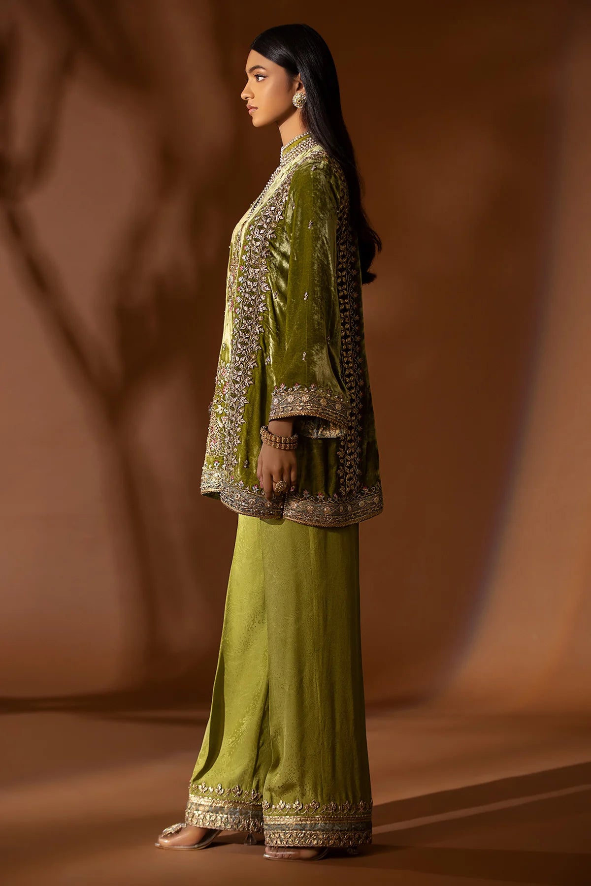 Olive green velvet kurta with pearl, sequin, and gotta embroidery, paired with embossed silk pants and organza dupatta – perfect for festive 2025 wear.