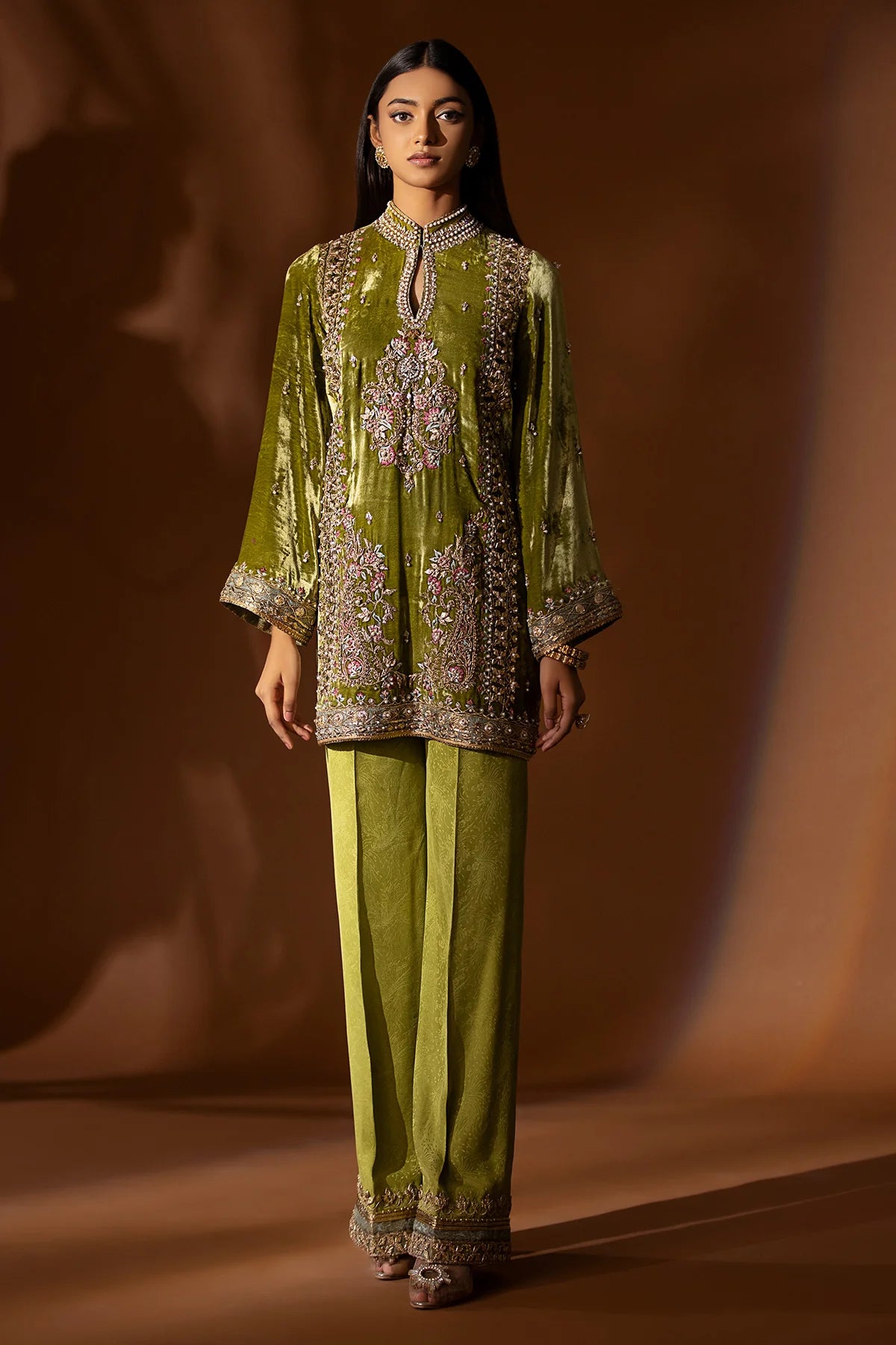 Olive green velvet kurta with pearl, sequin, and gotta embroidery, paired with embossed silk pants and organza dupatta – perfect for festive 2025 wear.