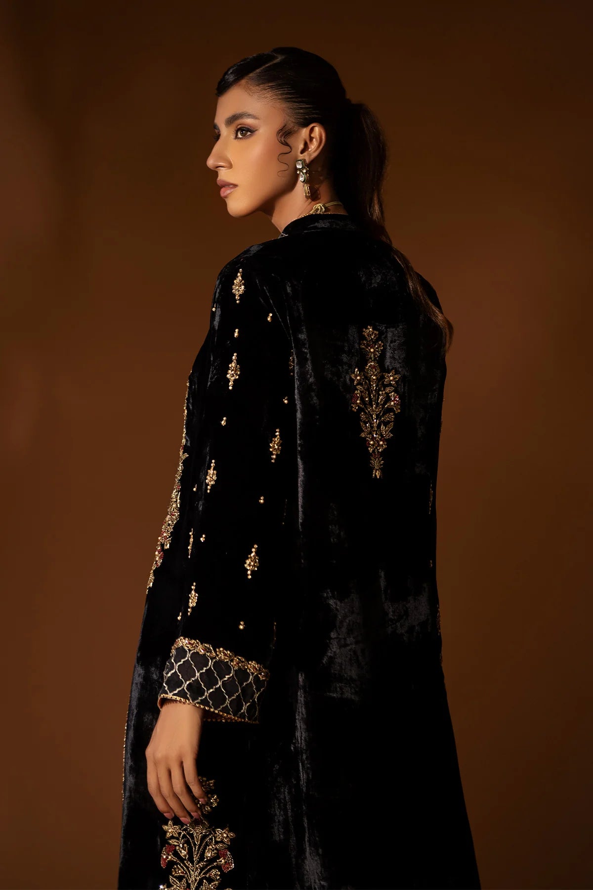Black velvet jacket with antique gold kora, dabka & resham, paired with crushed silk inner shirt – modern Pakistani formal outfit for 2025 events.
