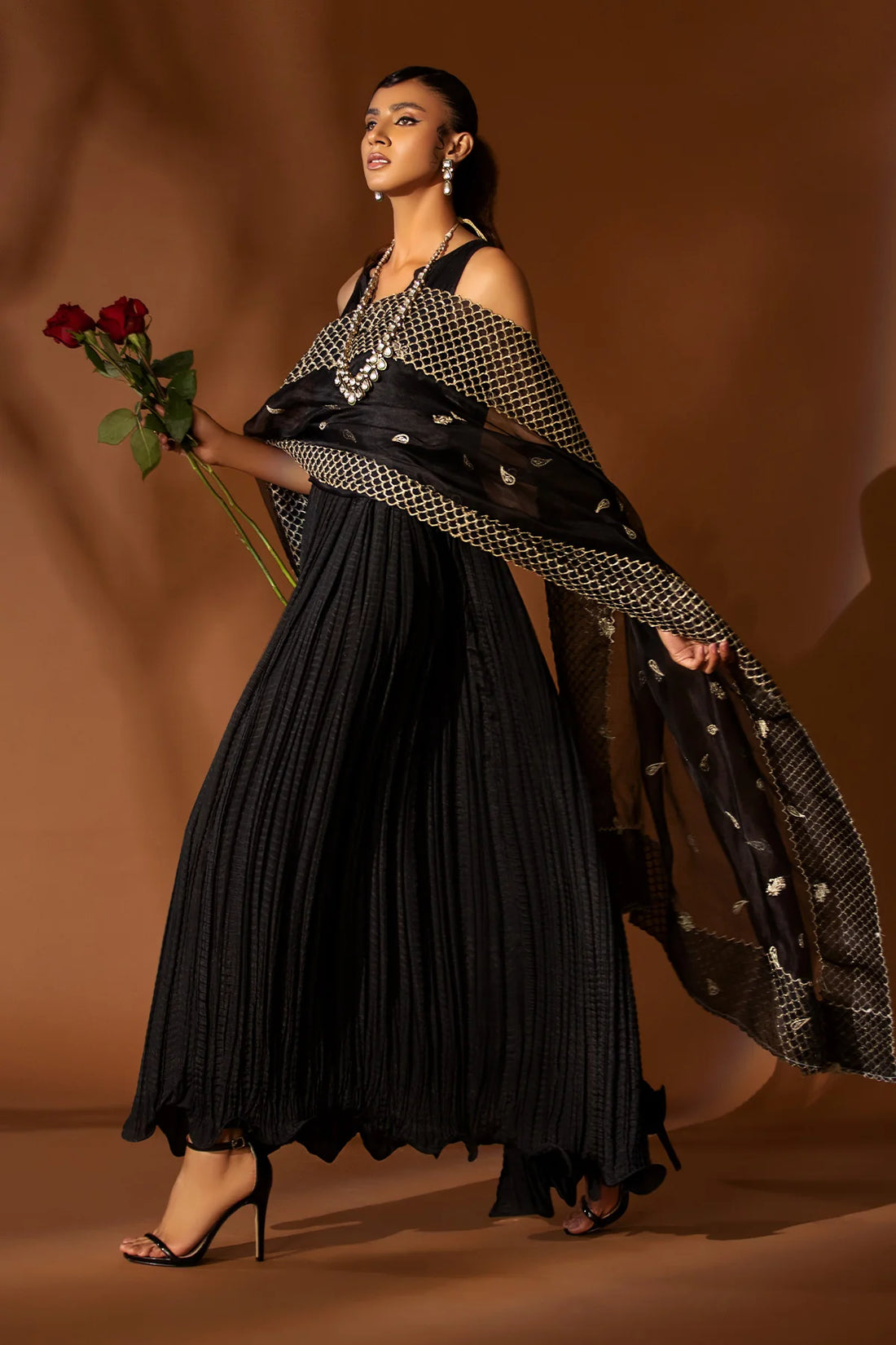 Black pleated silk outfit with gold embroidered organza dupatta – festive formal wear for women at Pakistanimoda