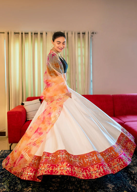Black and white raw silk Pakistani lehenga choli with mirror, pitta, and sequin embellishments, paired with black choli and tie-dye dupatta – ideal for receptions and formal events.