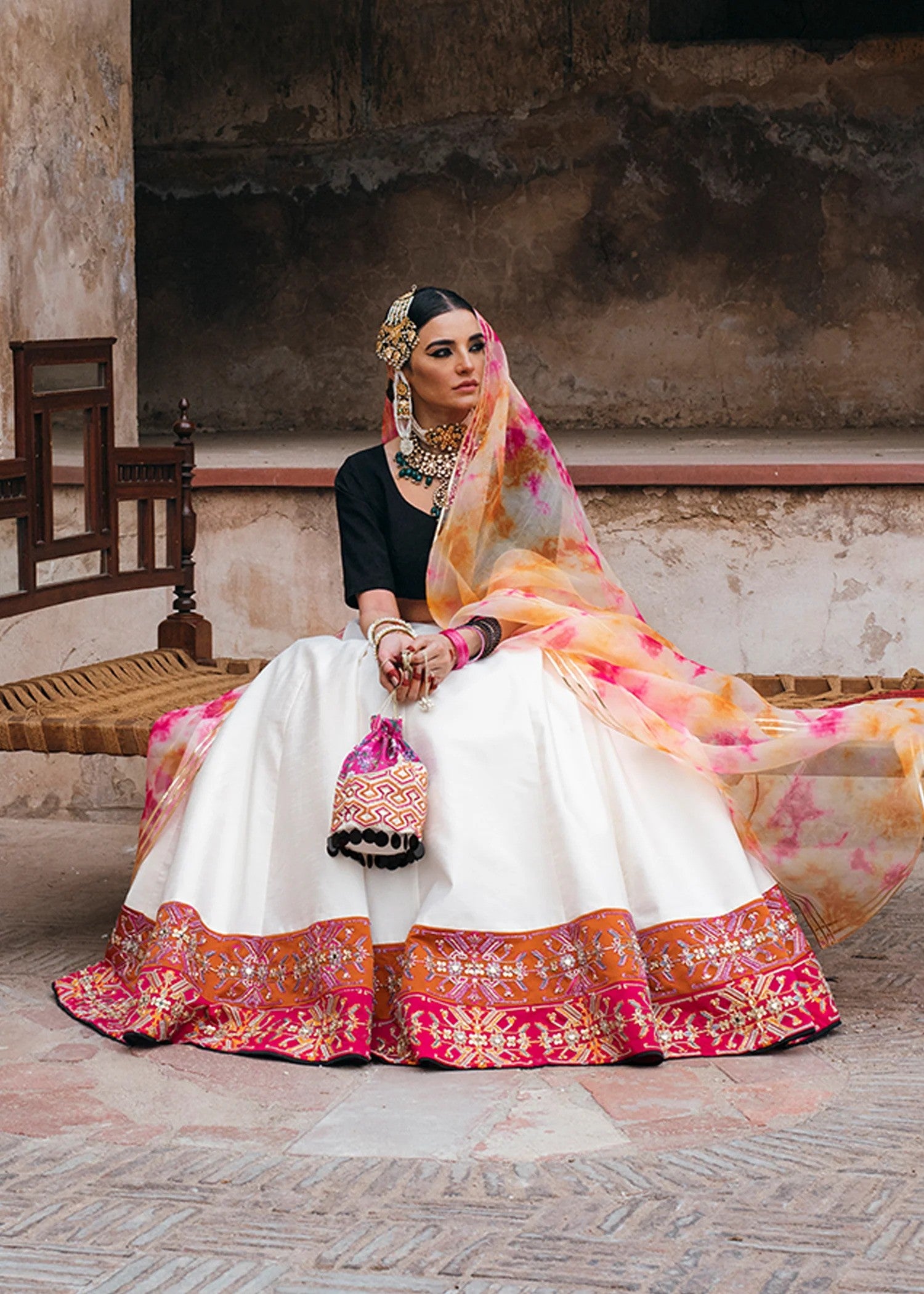 Black and white raw silk Pakistani lehenga choli with mirror, pitta, and sequin embellishments, paired with black choli and tie-dye dupatta – ideal for receptions and formal events.