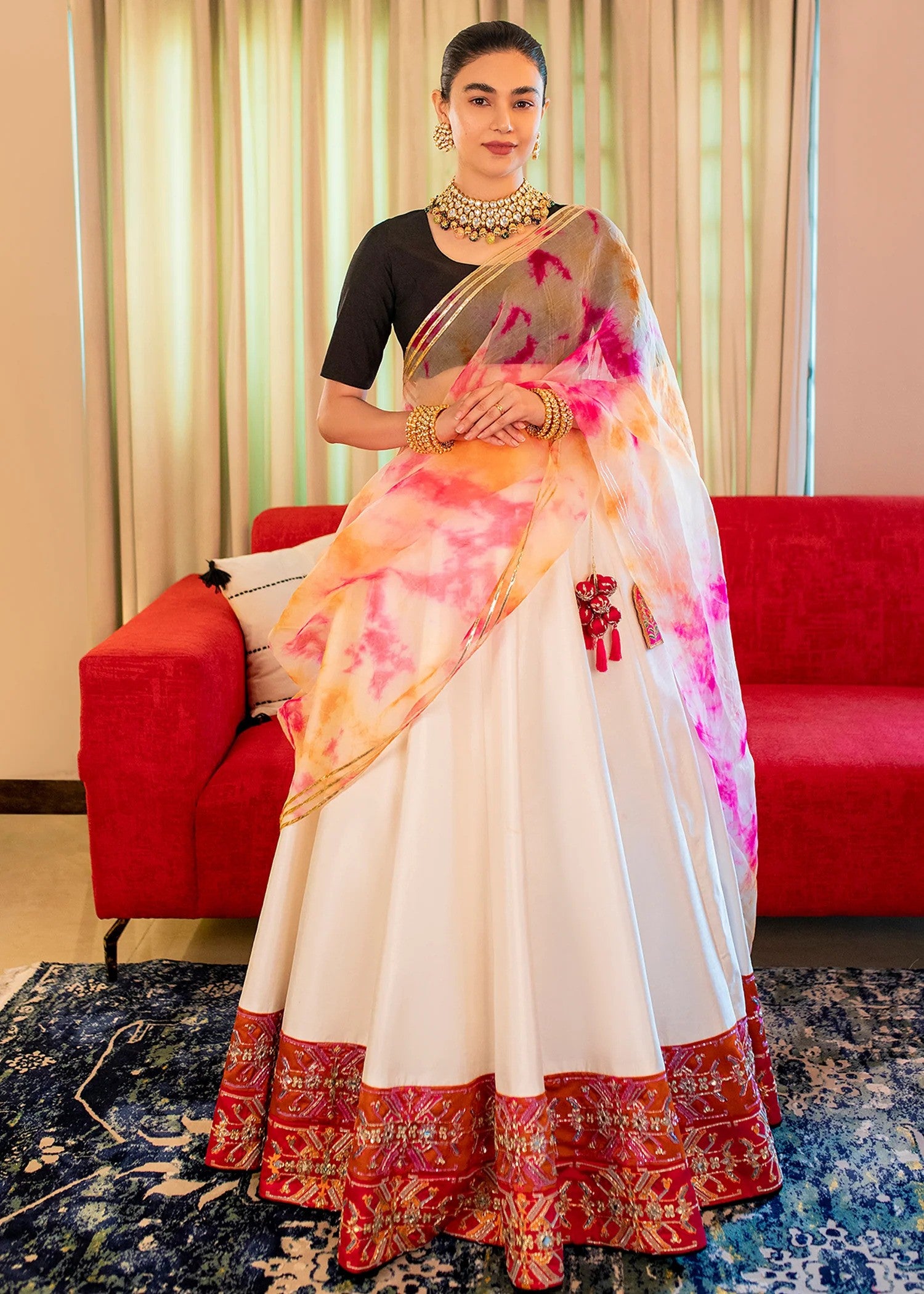 Black and white raw silk Pakistani lehenga choli with mirror, pitta, and sequin embellishments, paired with black choli and tie-dye dupatta – ideal for receptions and formal events.